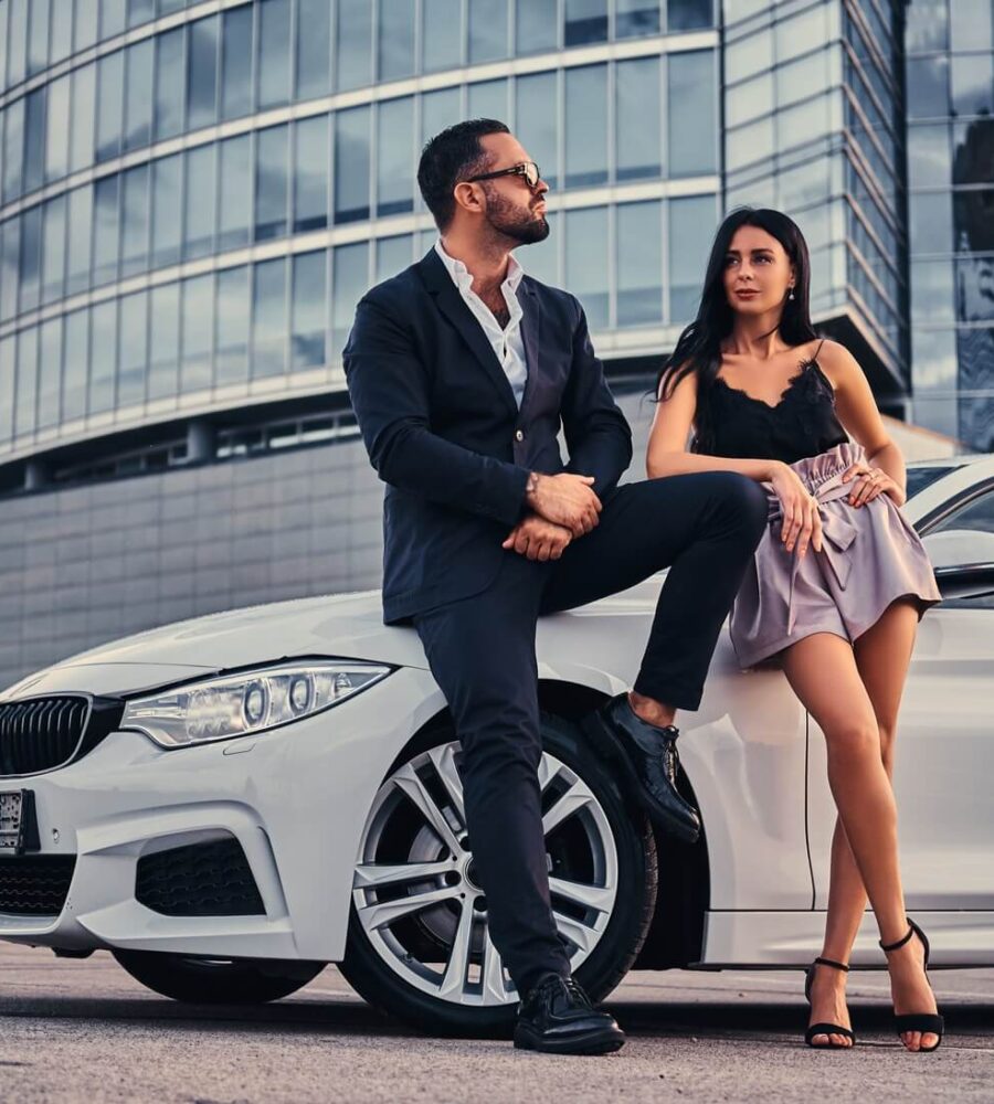 well-dressed-attractive-couple-leaning-luxury-car-outdoors-against-skyscraper (1) well-dressed-attractive-couple-leaning-luxury-car-outdoors-against-skyscraper (1)